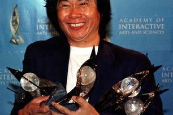 Shigeru Miyamoto holding five of the eleven awards that "The Legend of Zelda: Ocarina of Time" won at the Academy of Interactive Arts and Sciences Achievement Award in Los Angeles (May 13,